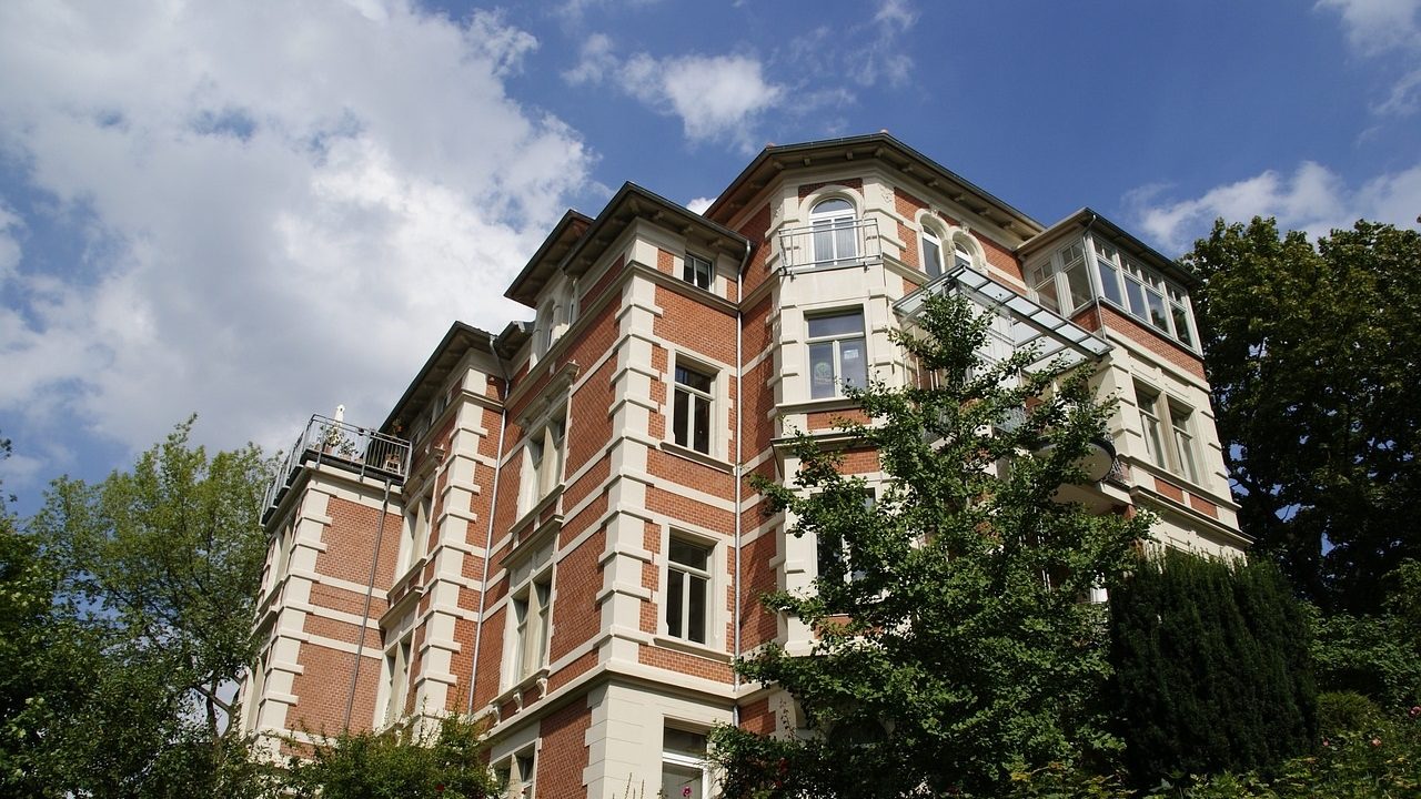 Ein Mehrfamilienhaus mit mehreren Bäumen drum herum, welches von unserer Hausverwaltung in Braunschweig betreut wird